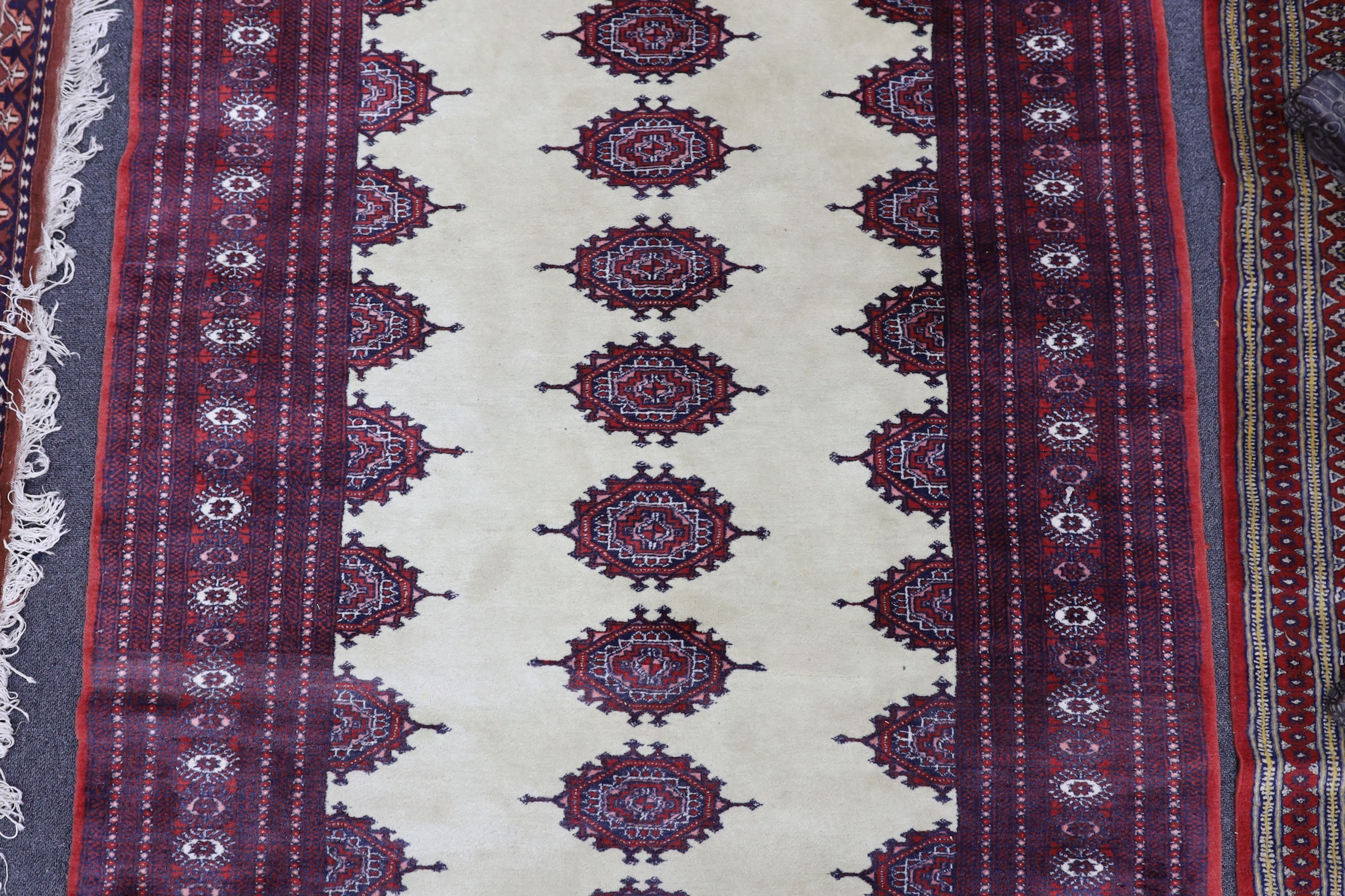 A Bokhara ivory ground rug, 190 x 125cm